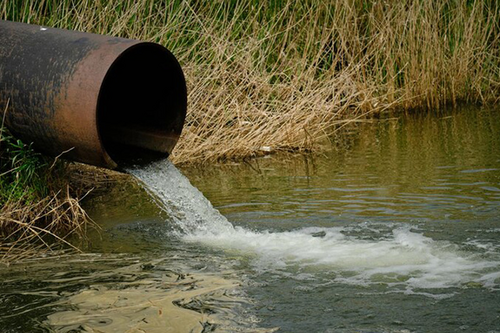 A sewage pipe running into a body of water