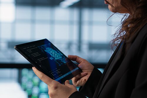 Someone holding a tablet using an AI chatbot